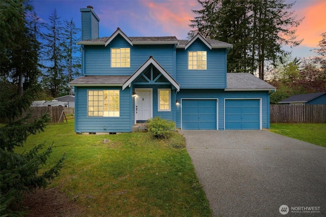 traditional-style house with fence, a chimney, driveway, and a front yard