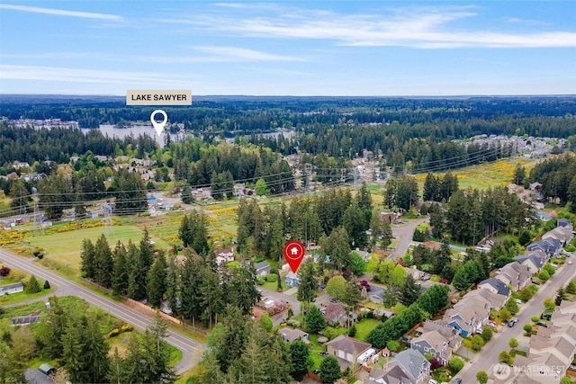 birds eye view of property with a view of trees