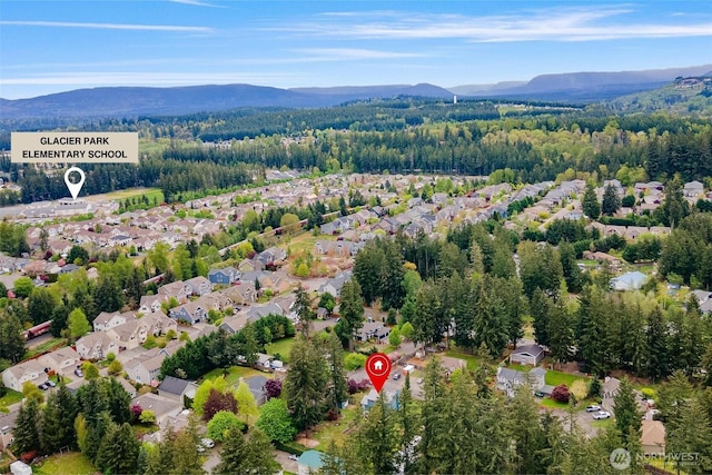 aerial view with a forest view, a residential view, and a mountain view