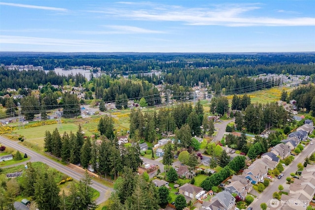 birds eye view of property featuring a wooded view