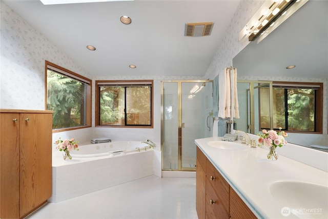full bathroom with visible vents, a sink, plenty of natural light, and wallpapered walls