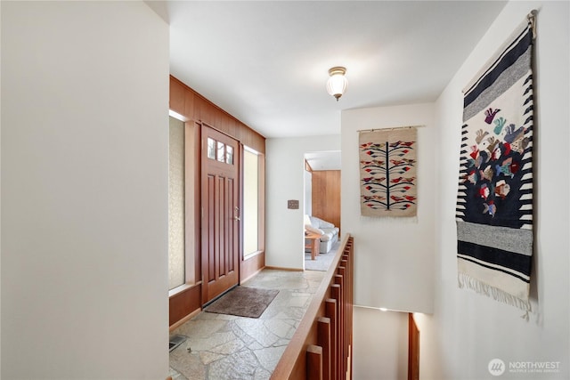 foyer entrance featuring stone finish flooring