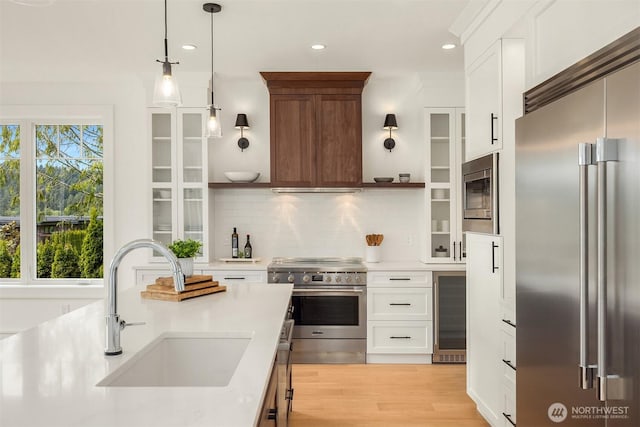 4815 Rosalind Rd NE, Bainbridge Island, WA 98110 - kitchen featuring premium appliances, a sink, wine cooler, open shelves, and light countertops
