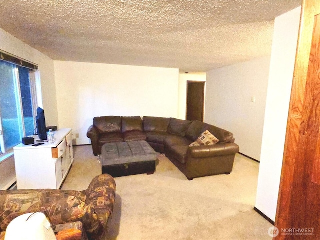 living area featuring light carpet and a textured ceiling