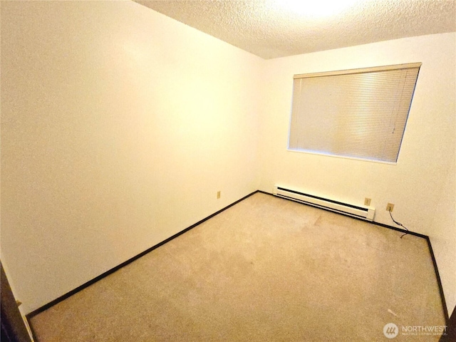 spare room with carpet floors, a textured ceiling, baseboards, and baseboard heating
