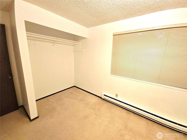 unfurnished bedroom featuring a closet, a textured ceiling, light carpet, and a baseboard radiator