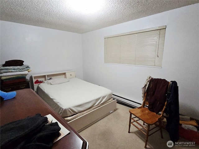 carpeted bedroom with a baseboard radiator and a textured ceiling