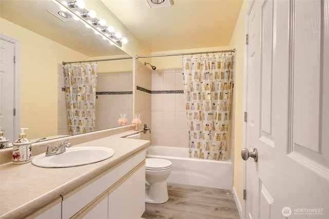 bathroom with vanity, toilet, wood finished floors, and shower / bath combination with curtain