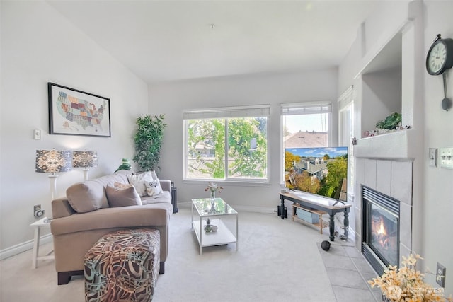 carpeted living room with a fireplace with flush hearth and baseboards