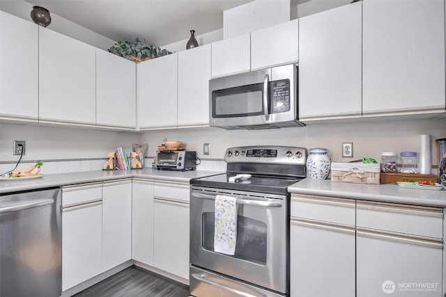 kitchen with light countertops, appliances with stainless steel finishes, and white cabinets
