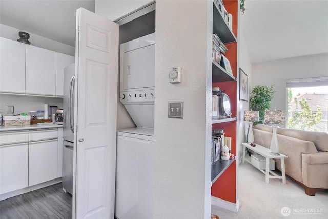 laundry room with laundry area and stacked washer / dryer