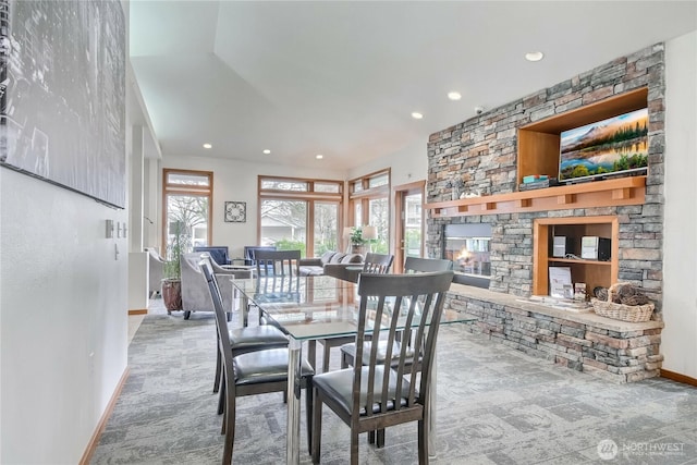 dining area featuring a fireplace, baseboards, carpet, and recessed lighting