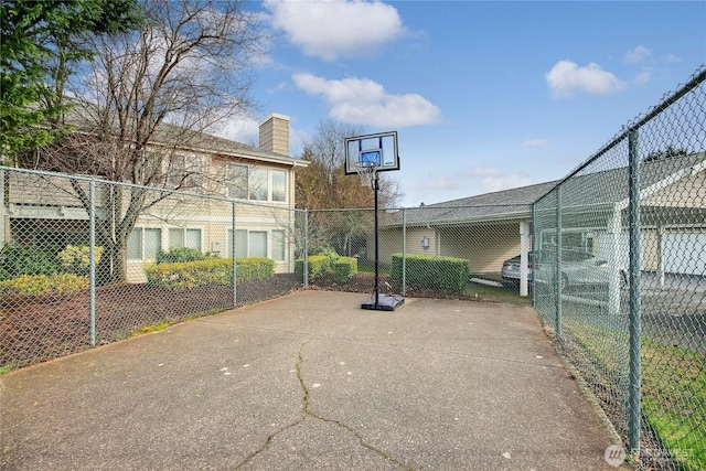 view of basketball court featuring fence and community basketball court