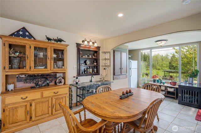28405 59th Ave NE, Arlington, WA 98223 - dining space with light tile patterned floors, arched walkways, and recessed lighting