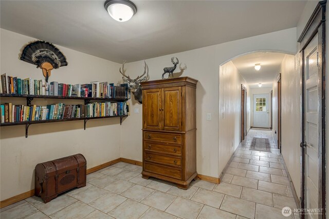 28405 59th Ave NE, Arlington, WA 98223 - hall with arched walkways, baseboards, and light tile patterned floors