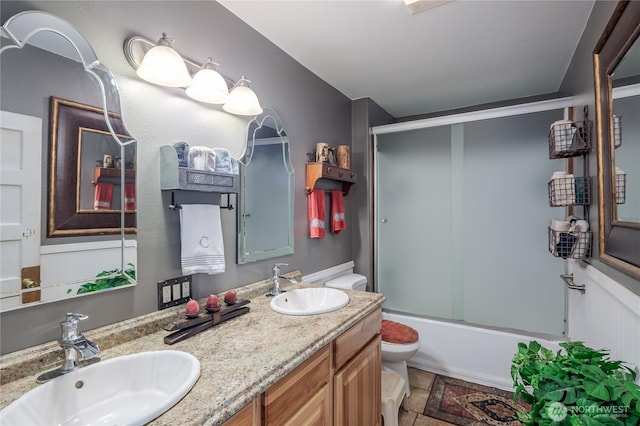 28405 59th Ave NE, Arlington, WA 98223 - bathroom featuring a sink, double vanity, toilet, and enclosed tub / shower combo