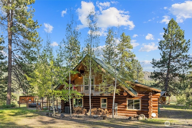 rear view of house with log siding