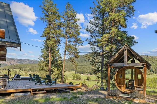 view of yard featuring a deck with mountain view