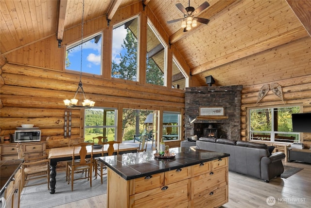 kitchen featuring wooden ceiling, high vaulted ceiling, open floor plan, light wood-style floors, and beam ceiling