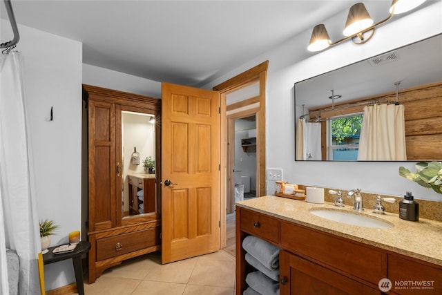 full bathroom featuring tile patterned flooring and vanity