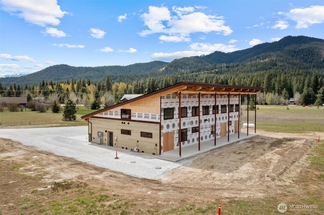 exterior space featuring a view of trees and a mountain view