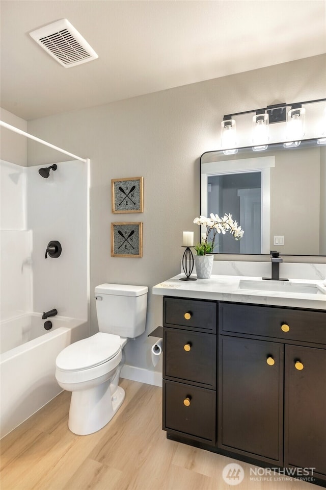 5732 Halls Lake Way, Lynnwood, WA 98036 - full bath with visible vents, vanity, wood finished floors, toilet, and shower / tub combination