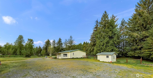 exterior space featuring fence and a storage unit