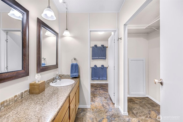 bathroom with baseboards and vanity