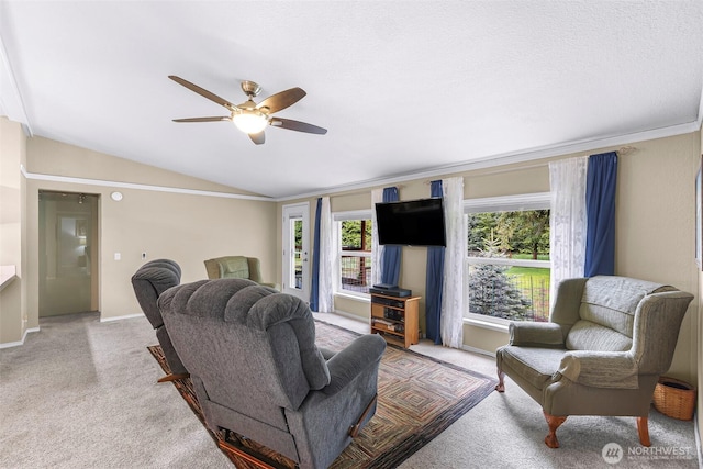 living room featuring a ceiling fan, baseboards, vaulted ceiling, and light carpet