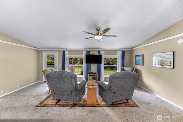 carpeted living area with ceiling fan, a healthy amount of sunlight, and lofted ceiling