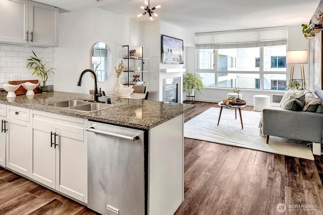 1420 Terry Ave Unit 603, Seattle, WA 98101 - kitchen with dishwasher, open floor plan, a sink, and dark wood-style floors