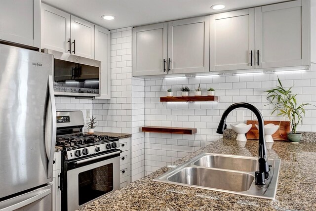1420 Terry Ave Unit 603, Seattle, WA 98101 - kitchen featuring stainless steel appliances, a sink, backsplash, stone countertops, and recessed lighting