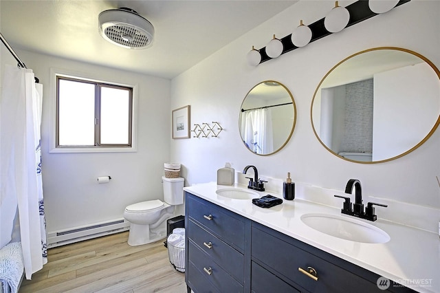 1892 Cascade View Dr, Camano Island, WA 98282 - bathroom with baseboard heating, toilet, a sink, and wood finished floors