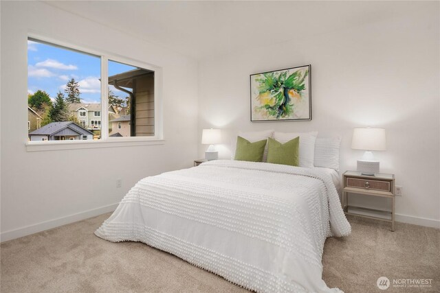 bedroom with baseboards and carpet