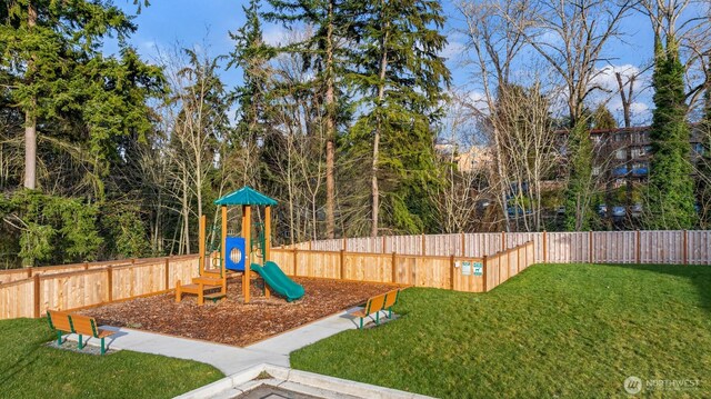 view of play area featuring a lawn and fence