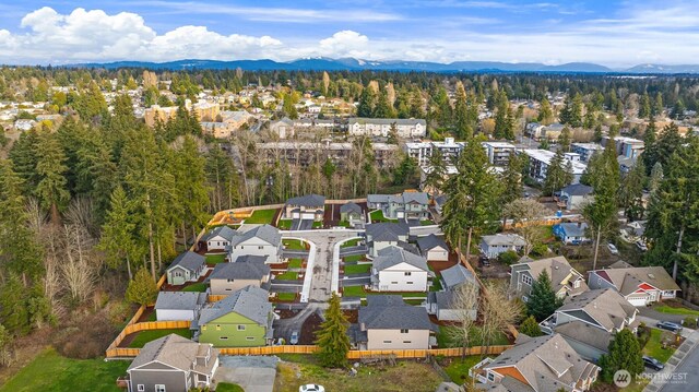 drone / aerial view featuring a residential view and a mountain view