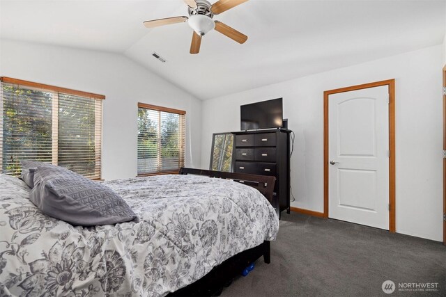 bedroom featuring a ceiling fan, vaulted ceiling, dark carpet, and visible vents
