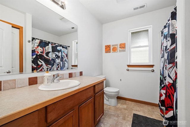 bathroom featuring toilet, baseboards, visible vents, and vanity