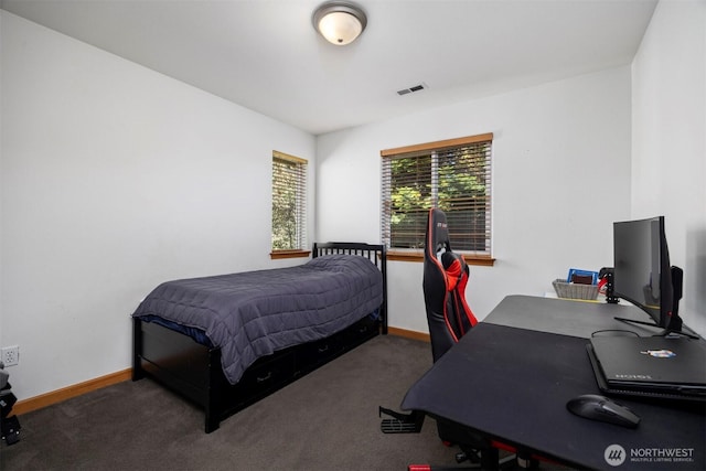 carpeted bedroom with visible vents and baseboards