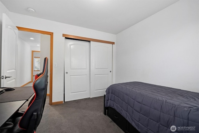 bedroom featuring recessed lighting, baseboards, dark carpet, and a closet