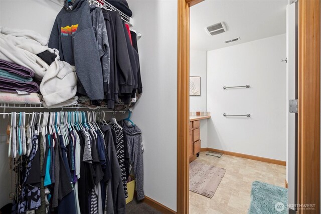 spacious closet featuring visible vents