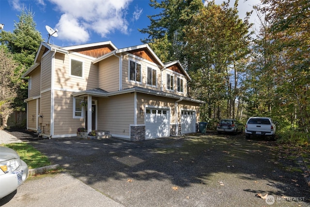 view of front facade featuring a garage, board and batten siding, and driveway