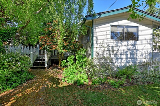 view of side of home with a deck