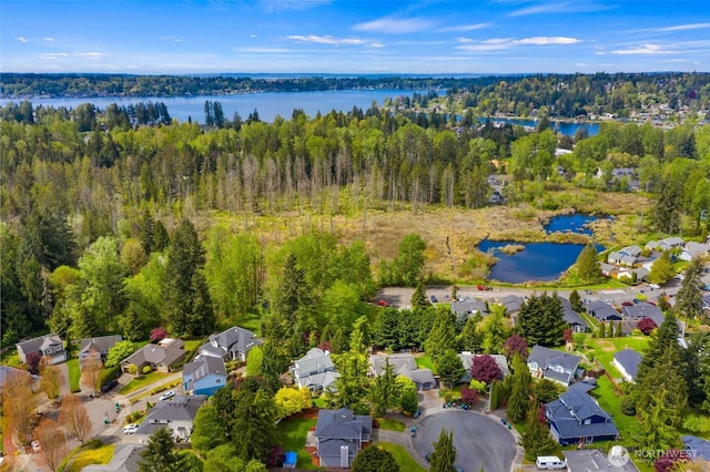 aerial view featuring a residential view, a view of trees, and a water view