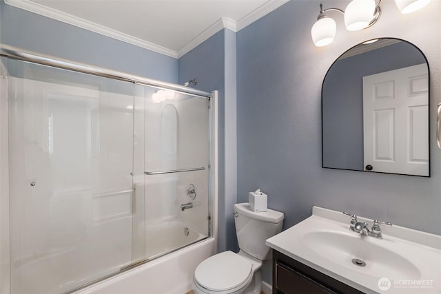 bathroom featuring vanity, ornamental molding, enclosed tub / shower combo, and toilet