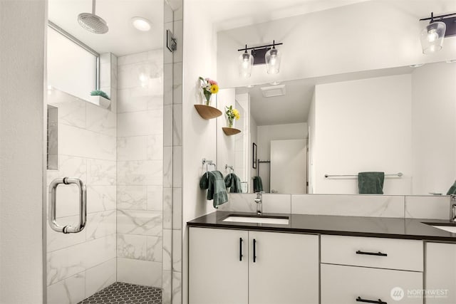 full bathroom featuring a shower stall and vanity