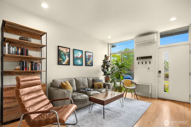 living area with plenty of natural light, an AC wall unit, and recessed lighting
