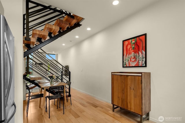 interior space with baseboards, recessed lighting, and wood finished floors