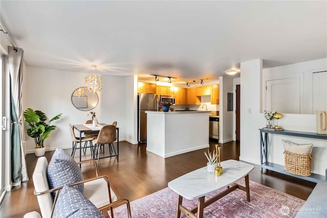 3661 Phinney Ave N Unit 208, Seattle, WA 98103 - living room with dark wood-style flooring, rail lighting, and an inviting chandelier