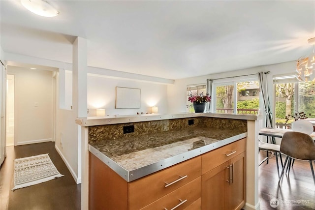 3661 Phinney Ave N Unit 208, Seattle, WA 98103 - kitchen featuring baseboards, brown cabinets, and dark wood-style floors